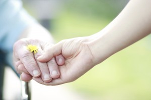 Young and senior women holding hands